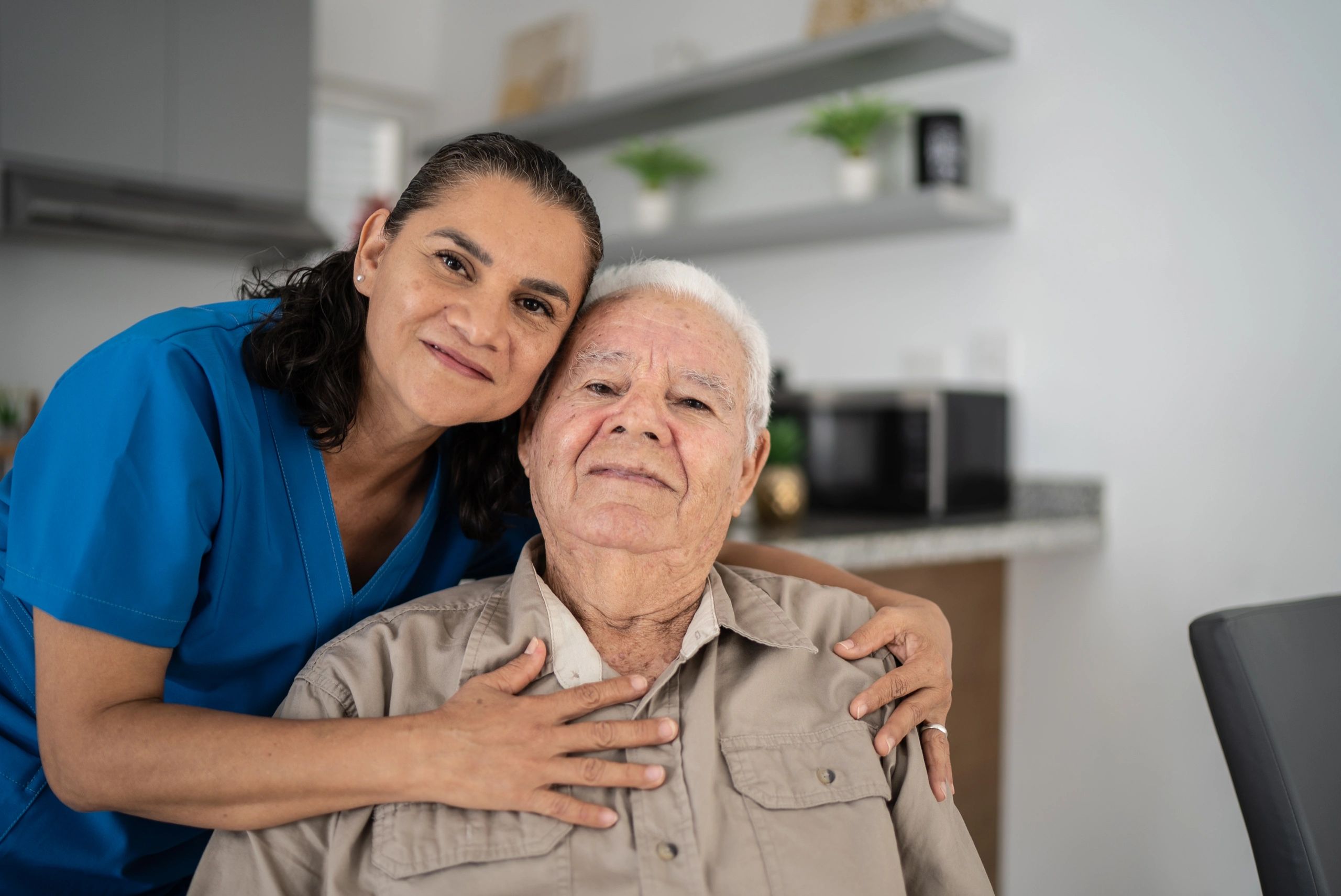 Nurse embracing senior man
